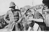 Major Poate cuts the hair of Colonel Howse VC, watched by Captain Tozer [ jpg ]