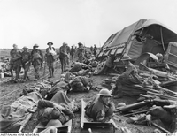 George Heydon (arm in sling) on the Menin Road near Hoog with injured waiting to be taken to clearing station [ jpg ]