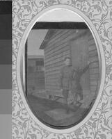 Frank standing at door of army hut [ jpeg ]